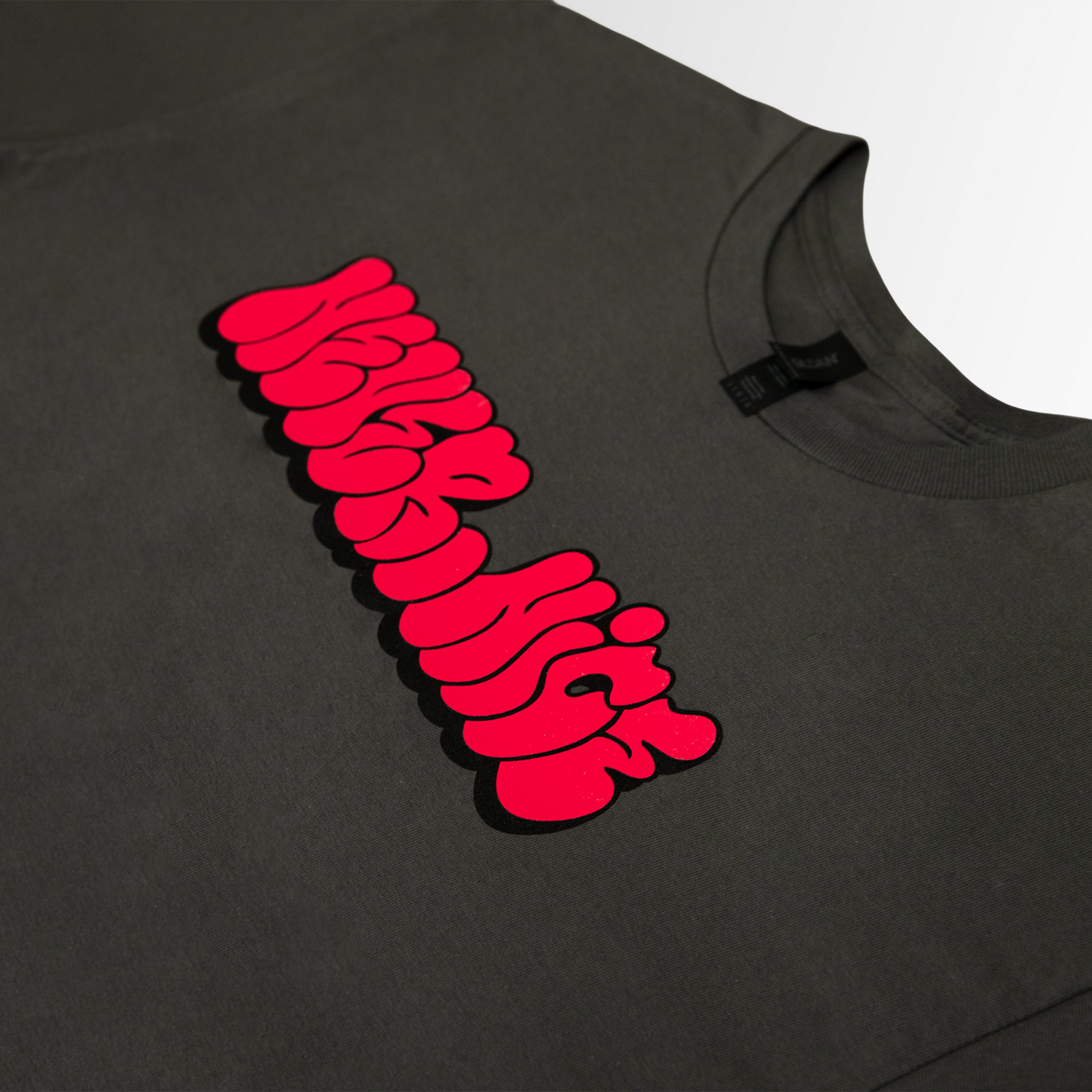 Grey t-shirt with a red graphic design on a gray background